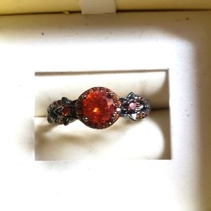 Black ring with fire orange stone